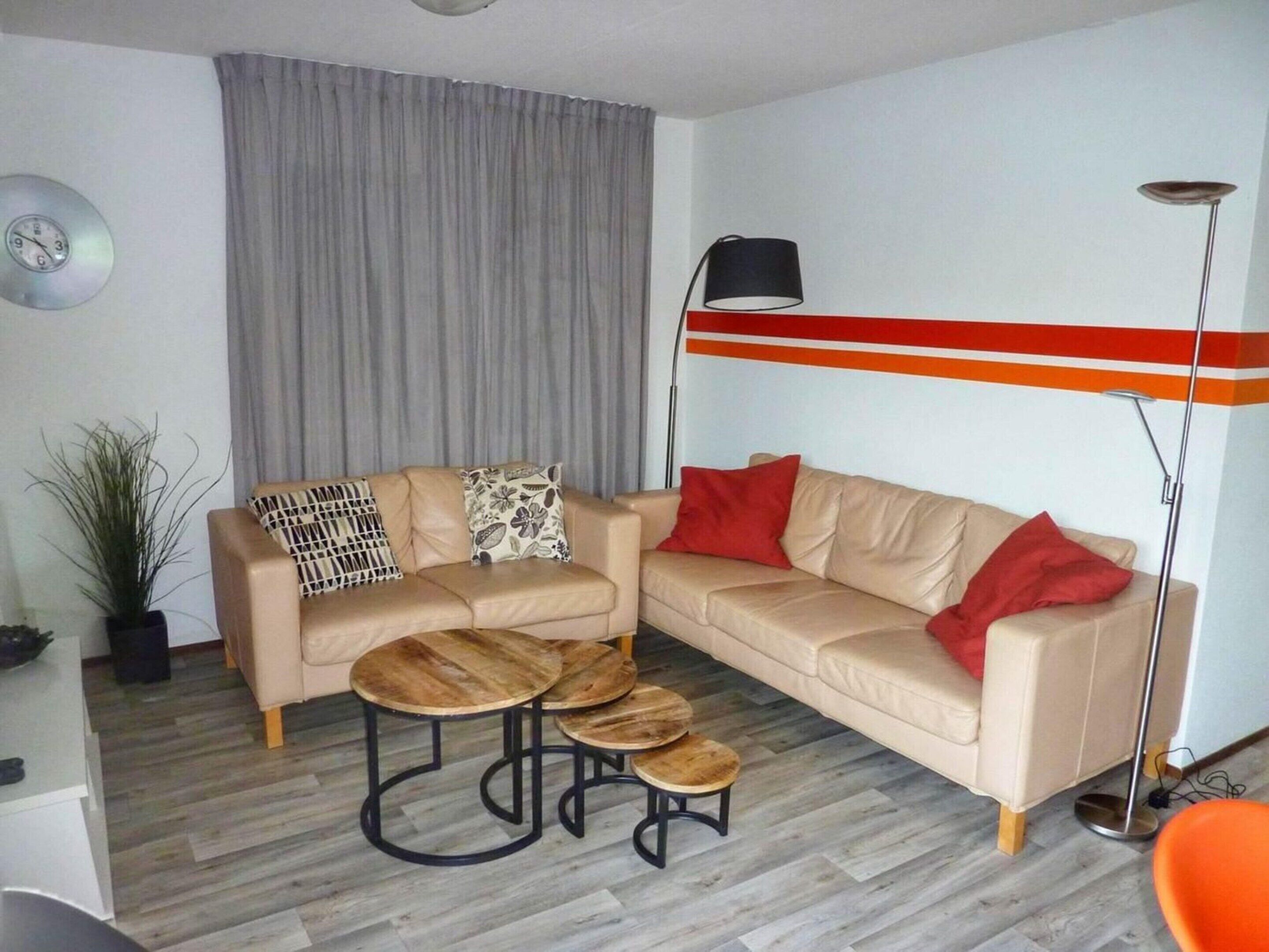 A living room with a beige sofa, a coffee table, and a floor lamp.