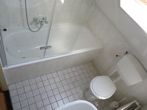 A bathroom with a glass-enclosed shower, a toilet, and a bidet. - Detached House Breskens Near Scenic Beaches (Breskens)