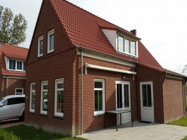 Stunning two-story home with a central entrance and symmetrical design.