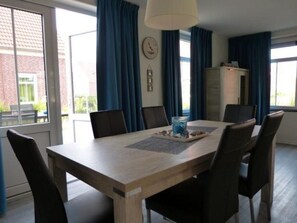 Enjoy meals and meetings in this stylish dining area with a large table and comfortable seating for six.