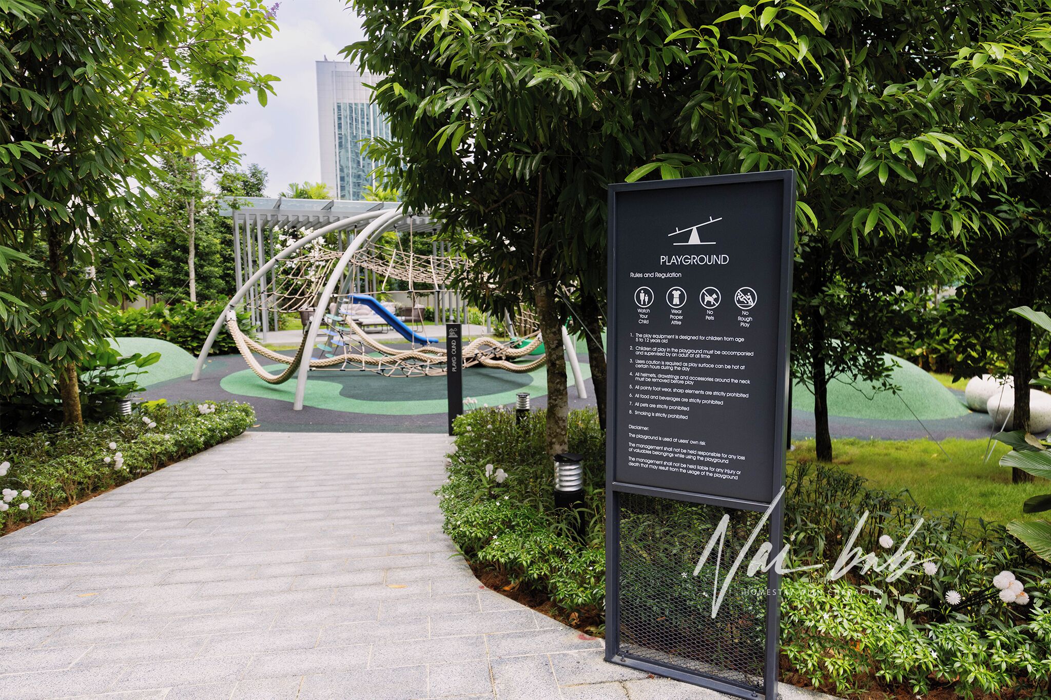 A playground area with a sign detailing rules and regulations.