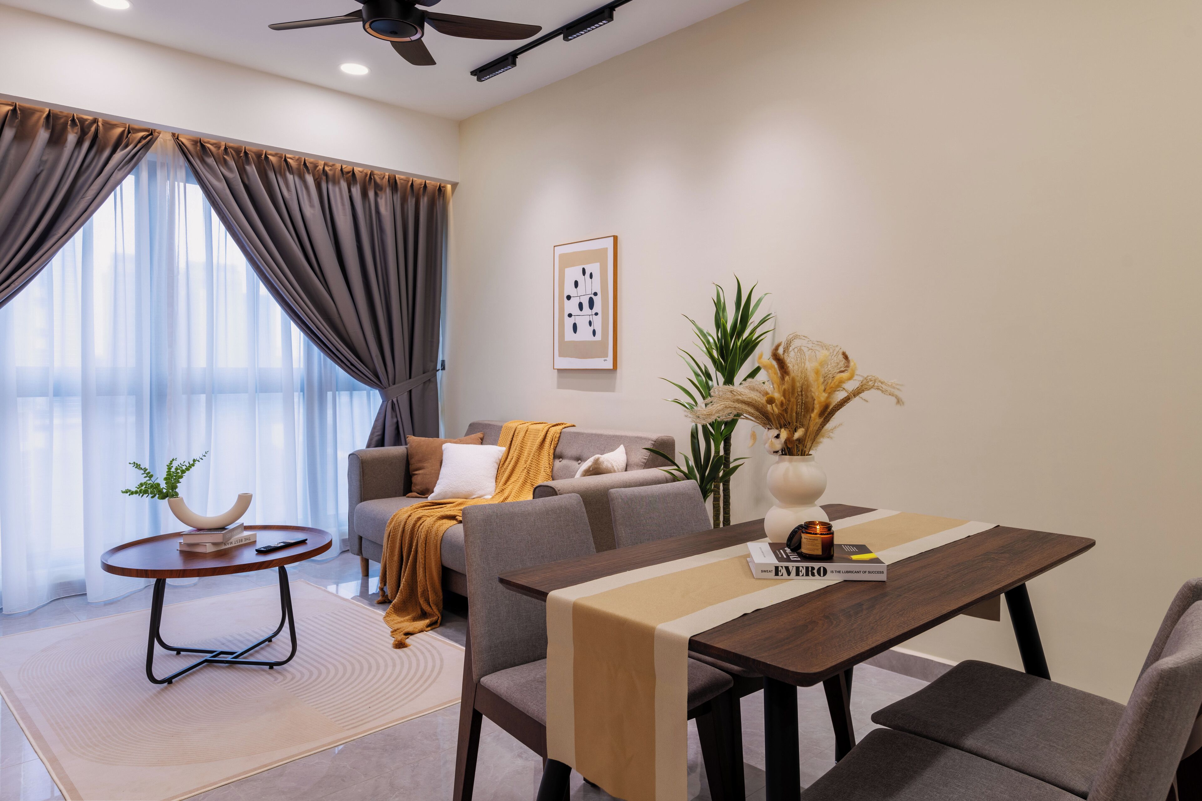 A modern living room with a sofa, a coffee table, and a dining table.