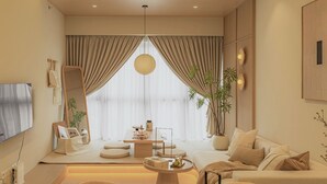 A modern living room with a sofa, a coffee table, and a TV mounted on the wall. - NaiBnB @ Agile Bukit Bintang (Kuala Lumpur)