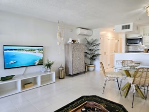 Enjoy a coastal view from the flat-screen TV, with a dining area and kitchenette nearby.