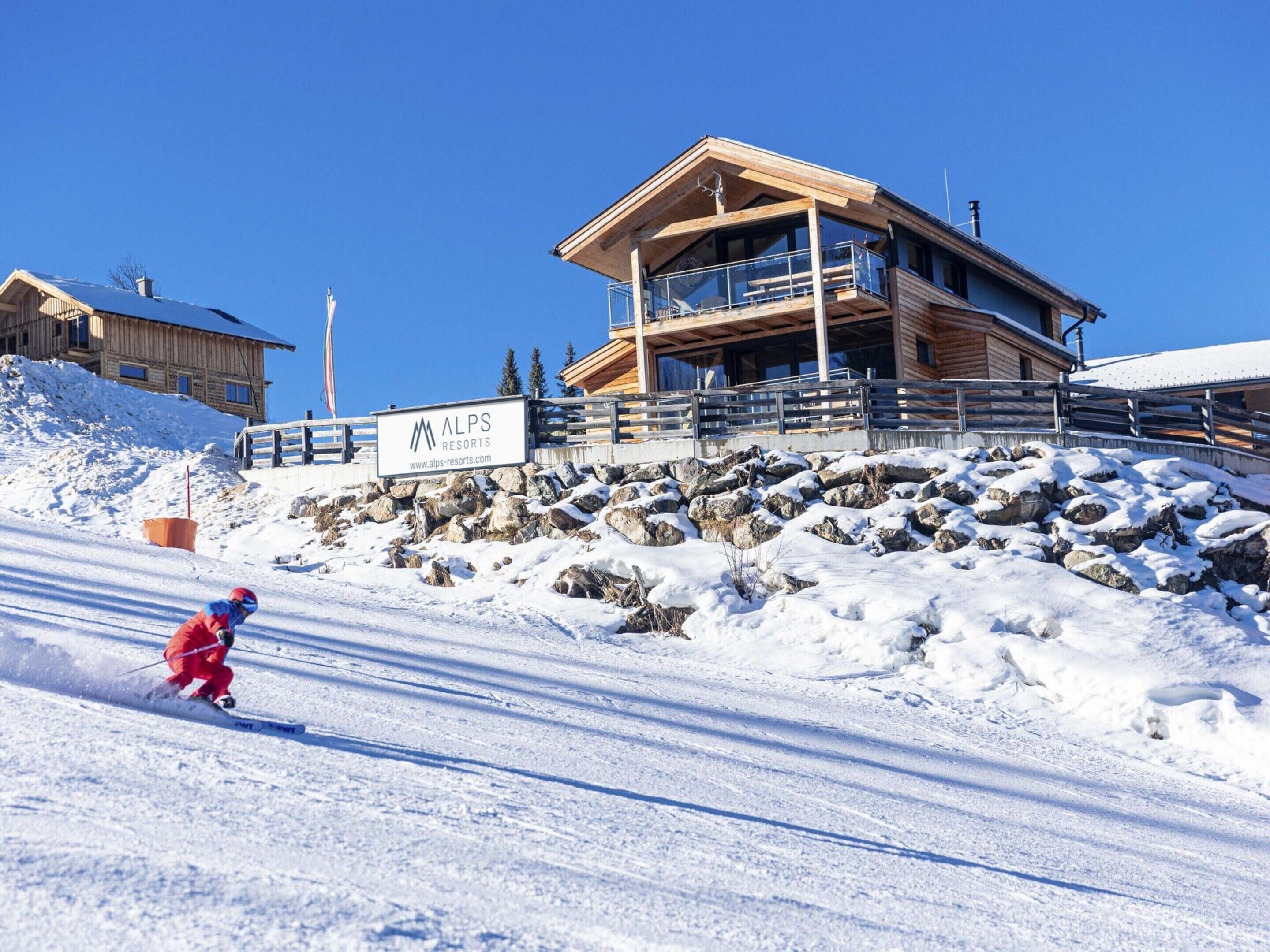 A ski resort building with a sign for ALPS RESORTS.