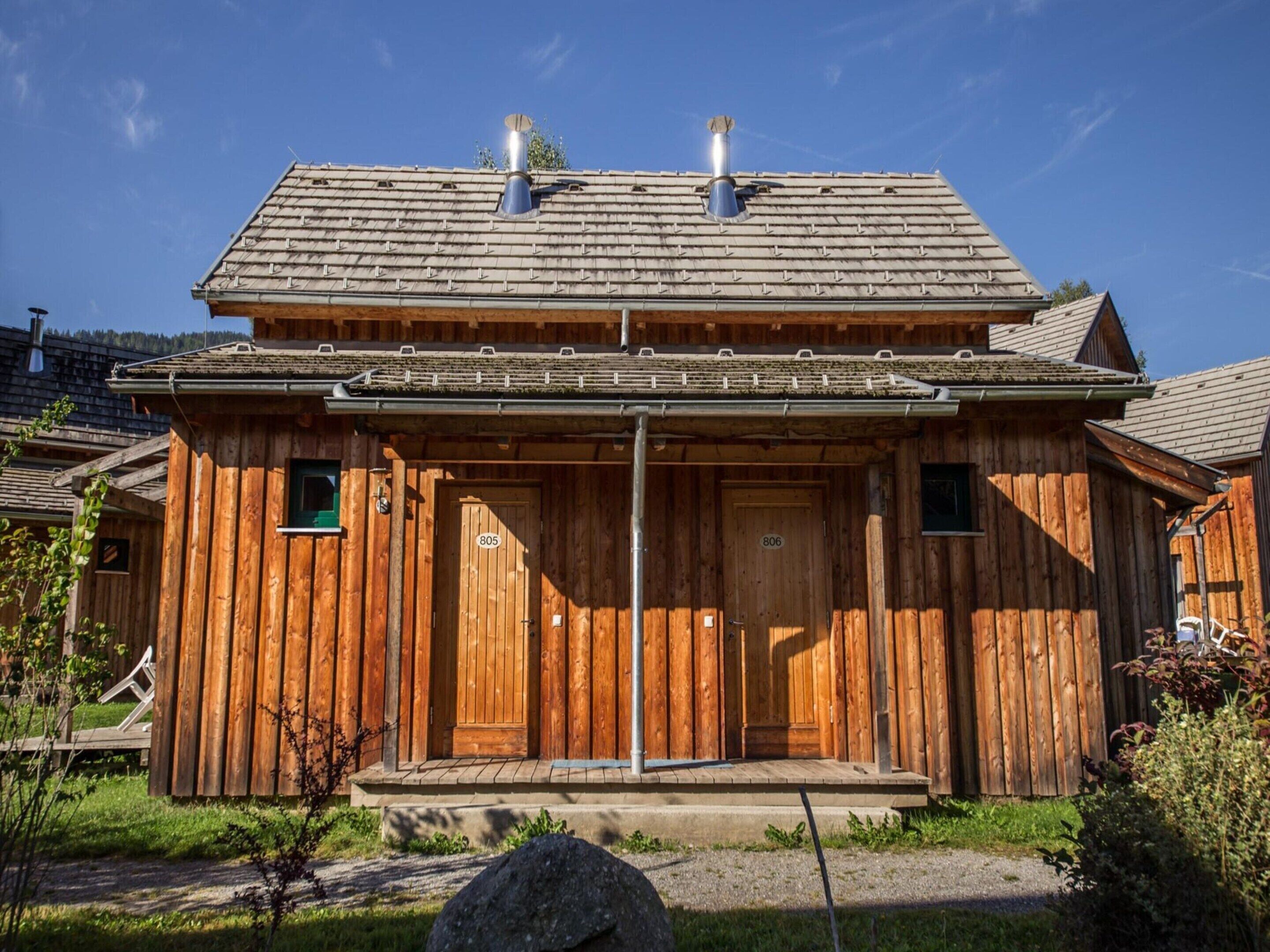 A wooden cabin with two doors, each marked with a number.