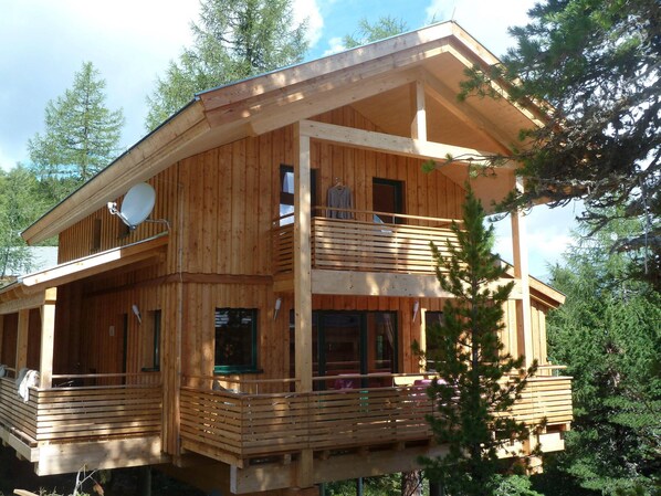 Enjoy a peaceful retreat with a balcony overlooking the surrounding trees.