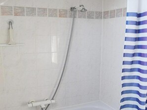 A shower with a handheld showerhead, a wall-mounted faucet, and a tiled shower enclosure. - Holiday Home Near Beach in Strandpark (Breskens)