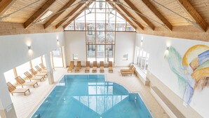 An indoor swimming pool with wooden beams and large windows. - Welcoming Chalet With Terrace (Sankt Georgen am Kreischberg)