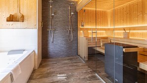 A modern bathroom with a wooden interior, a glass shower enclosure, and a built-in sauna. - Nice Chalet With Finnish Sauna (Schladming)