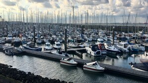 A marina filled with numerous boats docked at wooden piers. - Holiday Home Breskens Near Scenic Beaches (Breskens)