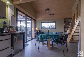 Enjoy meals in the spacious dining area with a round table set for four, surrounded by comfortable chairs.