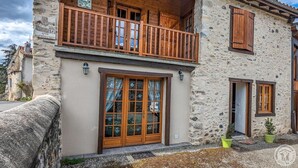 A two-story stone building with wooden balconies and large windows. - Le Castel Vert - Valcabrère (Valcabrère)