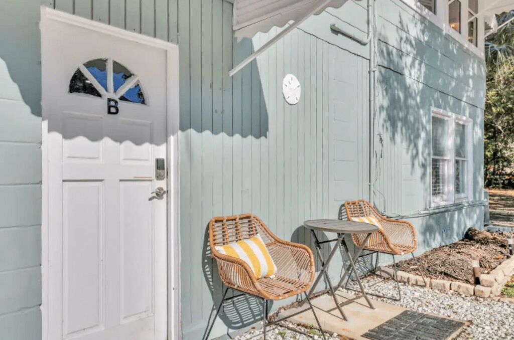A light blue house with a white door marked with a 'B'.