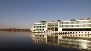 A large, multi-deck river cruise ship with a white exterior and multiple levels of balconies. - Le Fayan Nile Cruise - Mondays from Aswan & Thursdays from Luxor (Luxor)