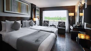 A hotel room with two beds, a balcony, a desk, and a TV. - Le Fayan Nile Cruise - Mondays from Aswan & Thursdays from Luxor (Luxor)