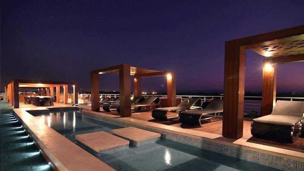A rooftop pool area with lounge chairs and wooden structures providing shade. - Le Fayan Nile Cruise - Mondays from Aswan & Thursdays from Luxor (Luxor)