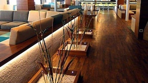 A spacious lobby with a long reception desk, seating area with sofas, and a wooden floor. - Le Fayan Nile Cruise - Mondays from Aswan & Thursdays from Luxor (Luxor)