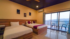 A hotel room with two beds, a wooden headboard, a ceiling fan, and a large window with a view. - Trattino Resorts (Wai)