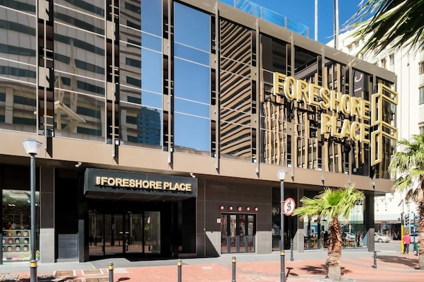 A modern building with a prominent sign reading "FORESHORE PLACE".