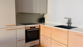 Deluxe Apartment, Courtyard View | Private kitchen | Electric kettle, toaster, dining tables