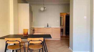 Deluxe Apartment, Courtyard View | Private kitchen | Electric kettle, toaster, dining tables