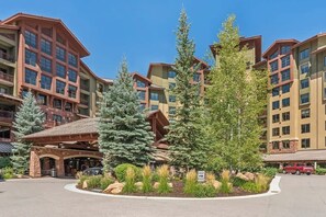 A multi-story hotel with a central courtyard, large windows, and a mix of stone and wood exterior. - Ski-In Out Grand Summit Penthouse w Private Sauna (Park City)