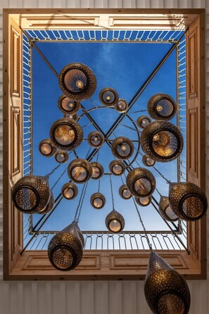 Eine Decke mit einem geometrisch gestalteten Metalllüster.