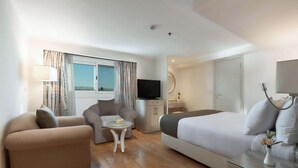 A modern hotel room with a large bed, two sofas, a small table, a TV, and a wardrobe. - Orient Sun Times Nile Cruise-Every Monday from Luxor for 04 & 07 Nights - Every Friday From Aswan for 03 Nights (Luxor)