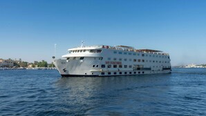A large white cruise ship named "M/S SUNTIMES" with multiple decks and passengers visible on the upper deck. - Orient Sun Times Nile Cruise-Every Monday from Luxor for 04 & 07 Nights - Every Friday From Aswan for 03 Nights (Luxor)