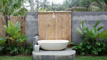 Separate bathtub and shower, slippers, towels, soap