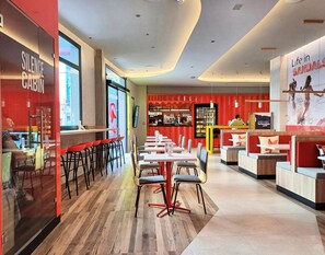 A modern restaurant interior with a bar area, seating arrangements, and a visible counter. - Sholeo Lodges Las Palmas Flats (Las Palmas de Gran Canaria)