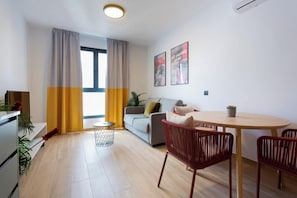 Basic Apartment, 1 Bedroom | Living area | 42-inch flat-screen TV with cable channels
