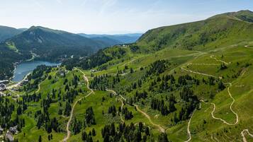 A mountainous landscape with winding roads and a lake.