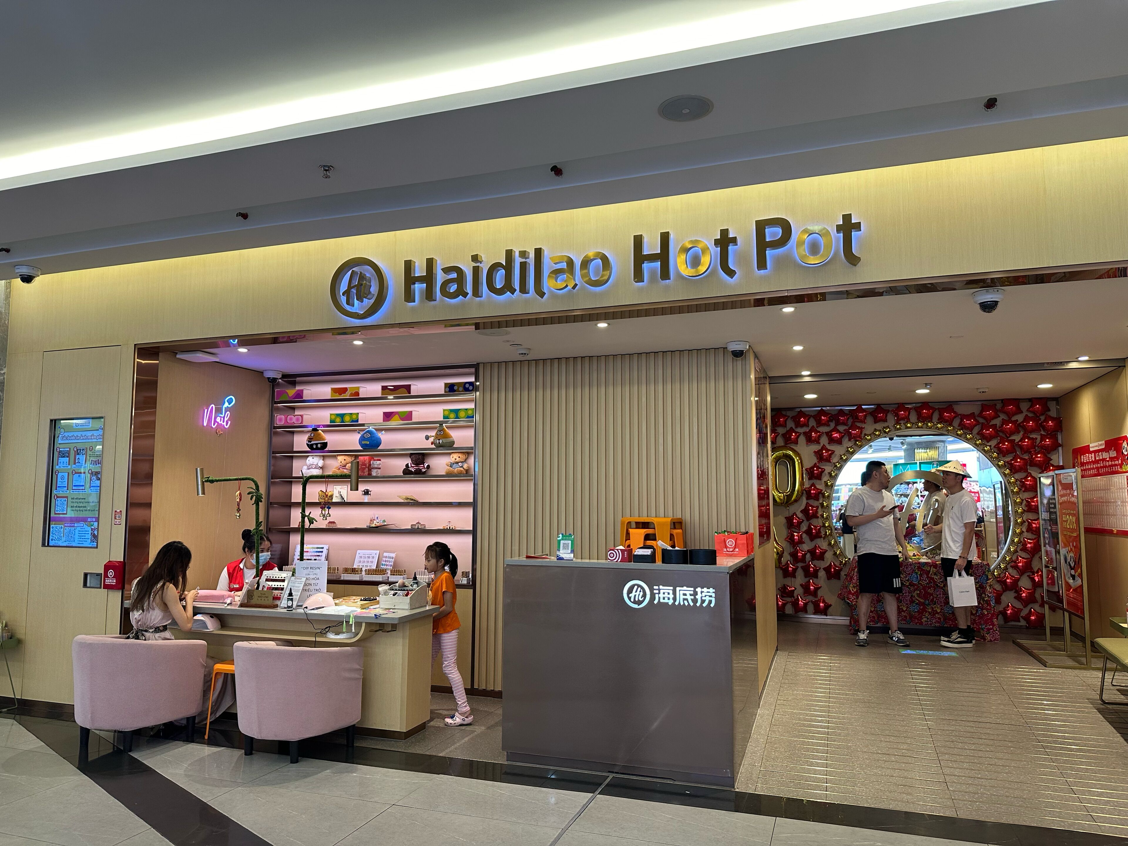 A storefront with a neon sign reading "Haidiao Hot Pot".