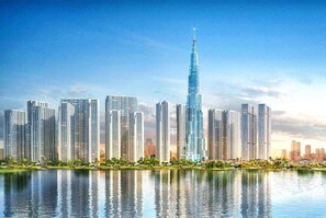 A cityscape with a prominent skyscraper, likely a hotel, surrounded by other high-rise buildings. - Vinhomes Central Park Premier Apartment (Ho Chi Minh City)