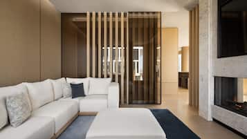 A modern living room with a sectional sofa, a fireplace, and a sliding glass door leading to an outdoor area.