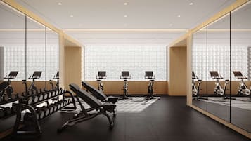 Un gimnasio moderno con equipo de ejercicio, ventanas amplias y un diseño limpio y minimalista.
