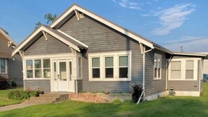A two-story house with a front porch, a garage, and a well-maintained lawn. - Wild Rose Cottage



Save
 (De Smet)