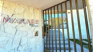 A stone wall with the name "MAKARE" and a keypad lock.