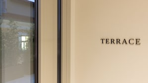 A sign with the word "TERRACE" on a wall. - Silk n Cotton (Athens)