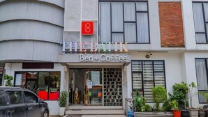 A building with a sign reading "THE BANK Bed & Coffee". - The Batik Bed and Coffee (Bandung)