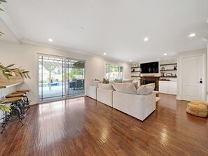 Relax in this spacious living area with a large sofa and patio views.