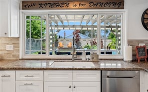 Enjoy a serene view from the kitchen window overlooking the backyard.