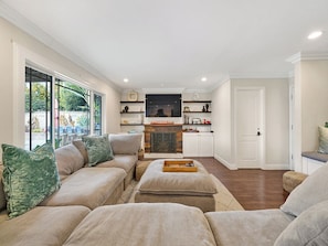 Relax in this inviting living space with a sofa, flat-screen TV, and oven.