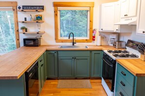 A compact kitchen with a microwave, sink, and stove. - Sugarloaf Mountain Fir Avenue C3004 (Carrabassett Valley)