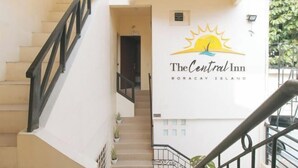 A staircase leading to a hotel entrance with a sign for The Central Inn Boracay Island. - RedDoorz @ The Central Inn Boracay Island (Boracay Island)