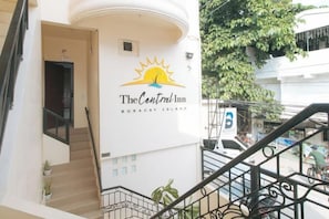 A hotel entrance with a staircase leading to a balcony. - RedDoorz @ The Central Inn Boracay Island (Boracay Island)