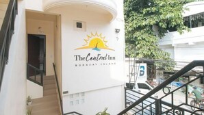 A hotel named "The Central Inn" with a sun logo, located on Boracay Island. - RedDoorz @ The Central Inn Boracay Island (Boracay Island)