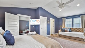 A hotel room with a large bed, a smaller bed, a desk with a chair, a wardrobe, and a sign that reads "Casago". - FR - Heber Historic Colonial (Heber City)